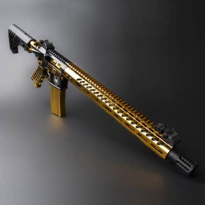 a gold and black rifle with a gun on top of it