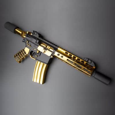 a gold - plated ake - ake - ake rifle on a gray background