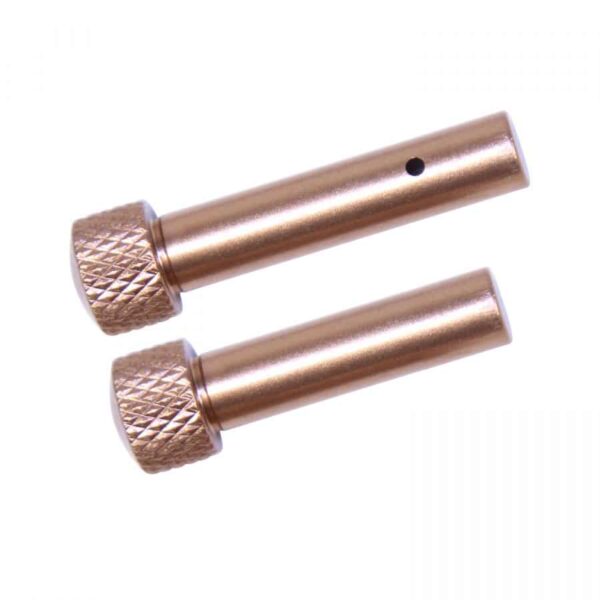 a pair of copper colored screws on a white background