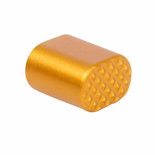 a gold colored pill shaped object on a white background