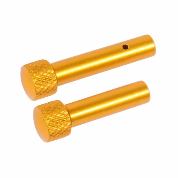 a pair of gold colored screws on a white background
