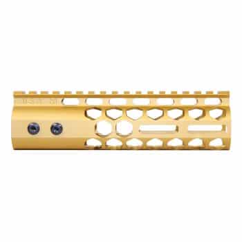 a gold rifle rail with holes on it