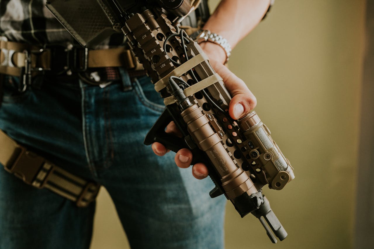 Detailed image of tactical gear and rifle, emphasizing military equipment and strategy.